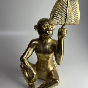 Grote metalen gouden aap met blad